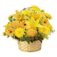 Deliver Yellow Lily, Gerbera, Rose, Carnation Basket 12 Online Rakhi Flowers to Delhi