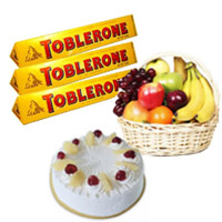500 gm Pineapple Cake with 1 Kg Fresh Fruits Basket and Toblerone Chocolates (300 gm) : Send Karwa Chauth Gift Hampers to Delhi